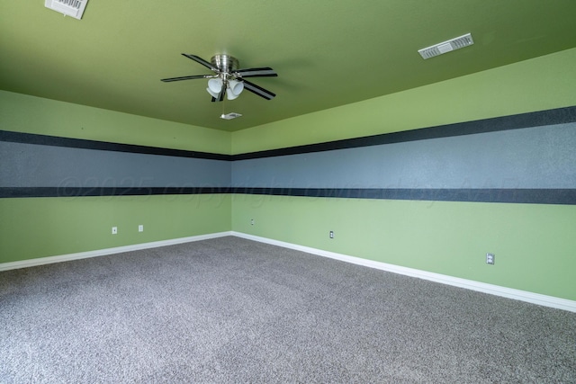 unfurnished room featuring baseboards, carpet floors, and visible vents