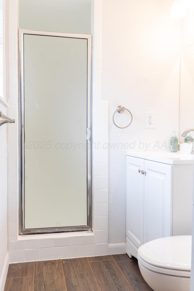508 S Austin St, Shamrock, TX 79079 - bathroom featuring a stall shower, vanity, and wood finished floors