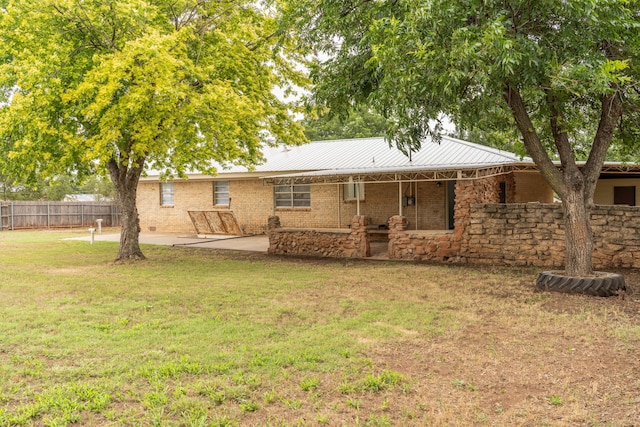508 S Austin St, Shamrock, TX 79079 - back of house featuring a patio area, a metal roof, and brick siding
