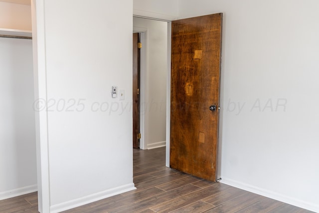 508 S Austin St, Shamrock, TX 79079 - unfurnished bedroom featuring a closet and dark wood-style flooring