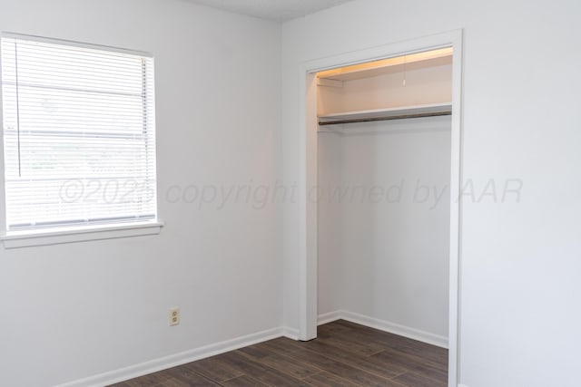 508 S Austin St, Shamrock, TX 79079 - unfurnished bedroom with dark wood-style floors and a closet