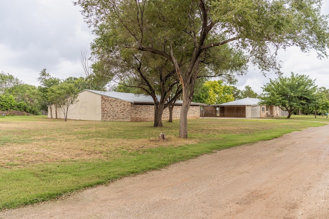 508 S Austin St, Shamrock, TX 79079 - view of side of property with a lawn, driveway, and brick siding
