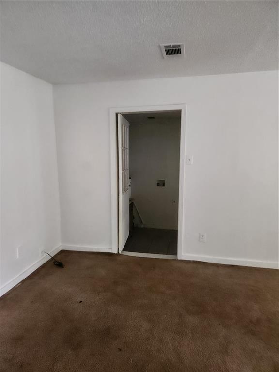 180 Carstens St, Mobile, AL 36617 - spare room with carpet flooring and a textured ceiling