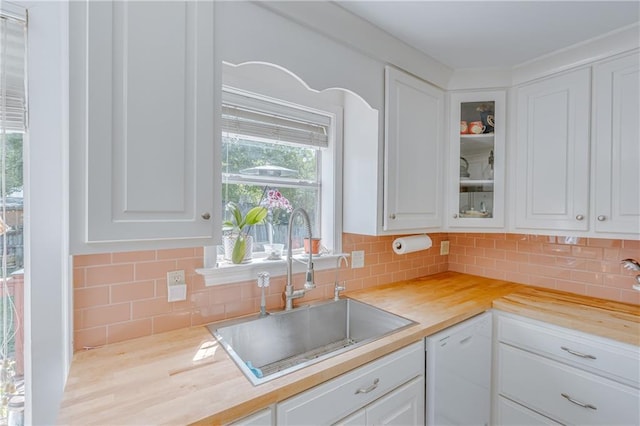 kitchen with a sink, white cabinetry, and dishwasher