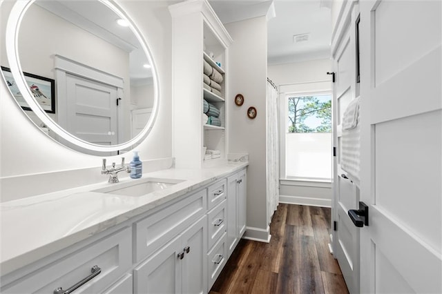 204 Magnolia Ct, Dauphin Island, AL 36528 - full bathroom featuring ornamental molding, vanity, baseboards, and wood finished floors