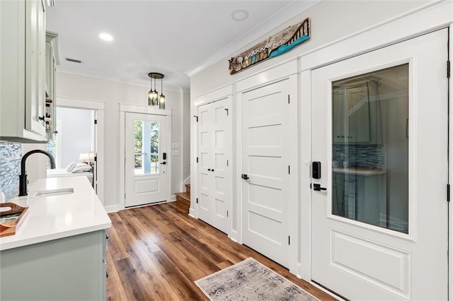 204 Magnolia Ct, Dauphin Island, AL 36528 - foyer with visible vents, ornamental molding, wood finished floors, recessed lighting, and stairway