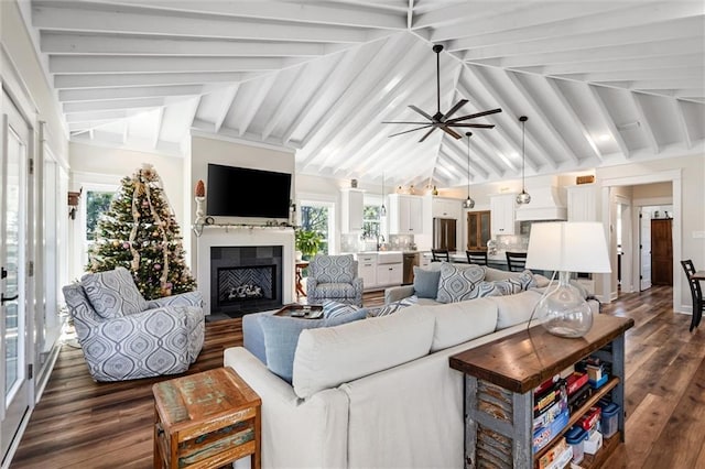 204 Magnolia Ct, Dauphin Island, AL 36528 - living room featuring high vaulted ceiling, a fireplace with flush hearth, dark wood-style flooring, ceiling fan, and beamed ceiling