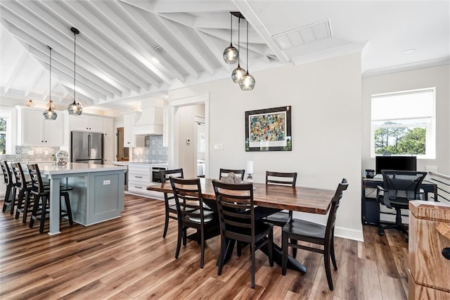 204 Magnolia Ct, Dauphin Island, AL 36528 - dining space featuring lofted ceiling with beams, wood finished floors, baseboards, and ornamental molding