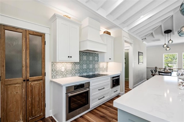 204 Magnolia Ct, Dauphin Island, AL 36528 - kitchen with stainless steel oven, black electric stovetop, light countertops, and custom range hood