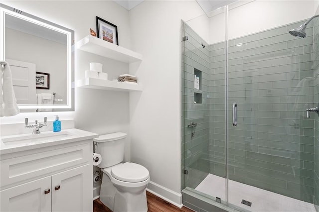 204 Magnolia Ct, Dauphin Island, AL 36528 - full bathroom with vanity, a shower stall, toilet, and wood finished floors