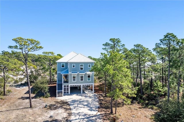 204 Magnolia Ct, Dauphin Island, AL 36528 - view of front of property with metal roof, stairs, a standing seam roof, and dirt driveway