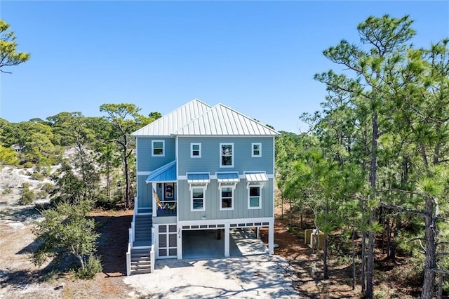 204 Magnolia Ct, Dauphin Island, AL 36528 - back of house with driveway, a standing seam roof, board and batten siding, metal roof, and a carport