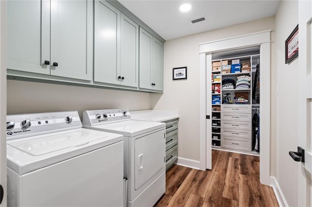 204 Magnolia Ct, Dauphin Island, AL 36528 - clothes washing area with visible vents, cabinet space, separate washer and dryer, baseboards, and dark wood-style flooring