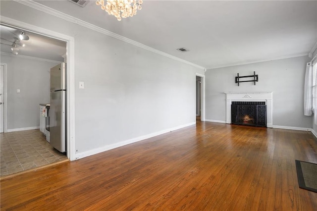 120 Shell Road Pl, Mobile, AL 36607 - unfurnished living room featuring crown molding, a chandelier, wood finished floors, and a warm lit fireplace