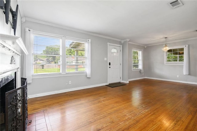120 Shell Road Pl, Mobile, AL 36607 - foyer with a chandelier, hardwood / wood-style floors, a fireplace, and crown molding