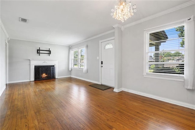 120 Shell Road Pl, Mobile, AL 36607 - unfurnished living room with wood finished floors, ornamental molding, a chandelier, and a warm lit fireplace