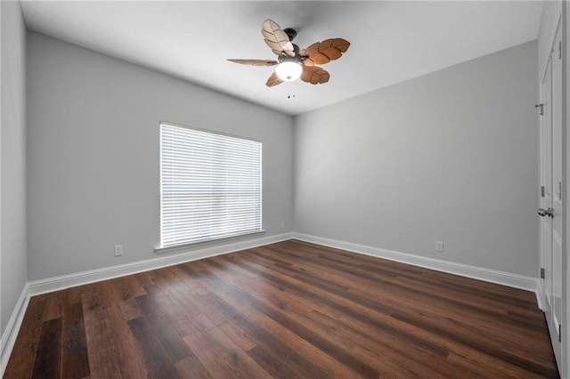 spare room with dark wood-type flooring and ceiling fan