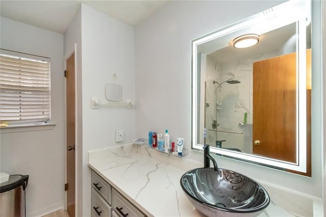 bathroom with vanity and a shower