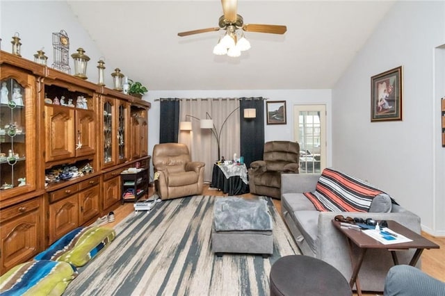 living room featuring vaulted ceiling, ceiling fan, and light wood-type flooring