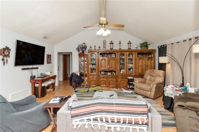 living room with lofted ceiling, ceiling fan, and light wood-type flooring