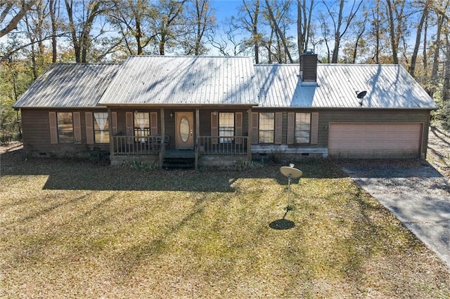 view of front of house featuring a garage, a front yard, and covered porch