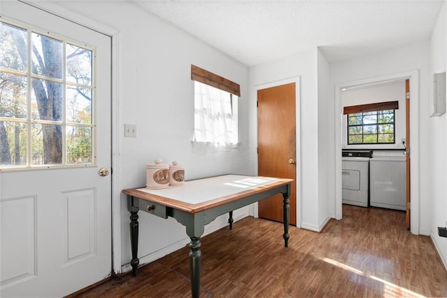 doorway featuring plenty of natural light, dark hardwood / wood-style floors, and washing machine and clothes dryer