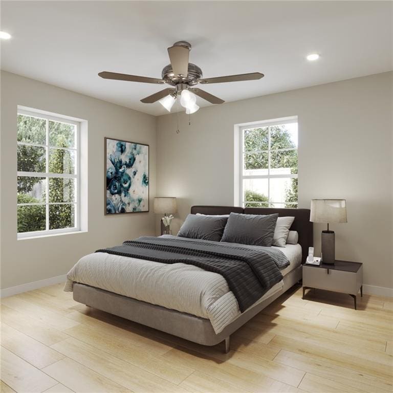 bedroom with multiple windows, ceiling fan, and light hardwood / wood-style floors