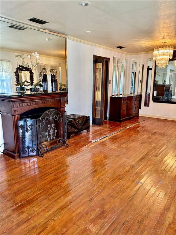 unfurnished living room featuring hardwood / wood-style floors and a notable chandelier