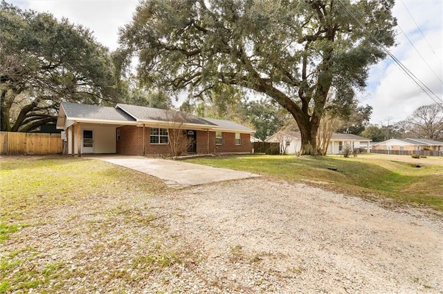 ranch-style house with a front yard and a carport