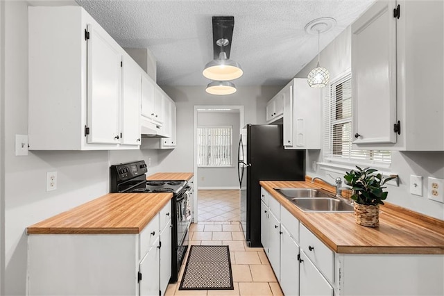 kitchen featuring sink, black appliances, white cabinets, a textured ceiling, and decorative light fixtures