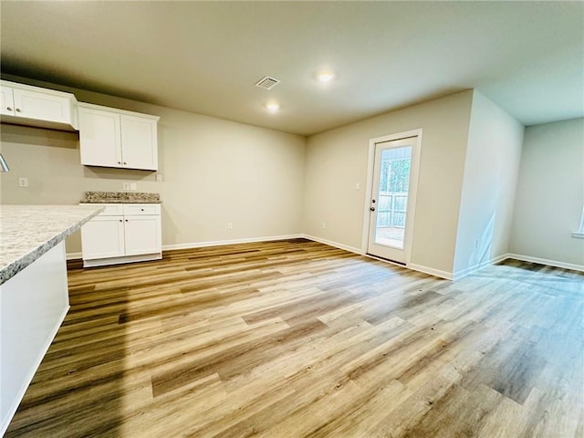 unfurnished dining area with light hardwood / wood-style floors