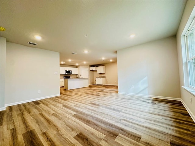 unfurnished living room with light wood-type flooring