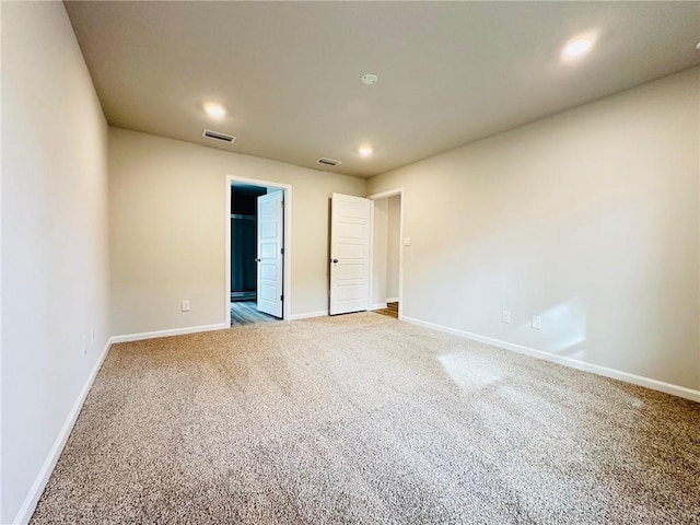 unfurnished bedroom featuring a spacious closet and carpet floors