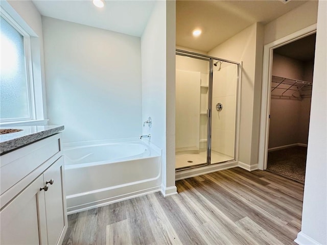 bathroom featuring vanity, hardwood / wood-style floors, and shower with separate bathtub