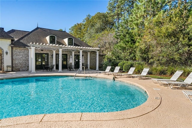 view of swimming pool with a pergola and a patio area