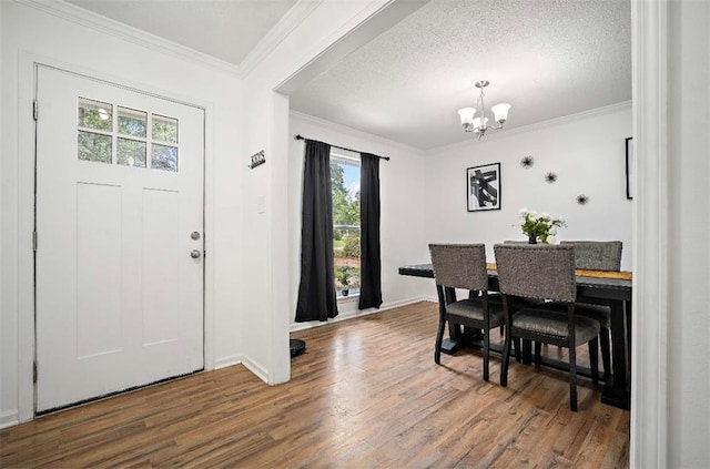 dining space featuring a wealth of natural light, dark hardwood / wood-style flooring, and an inviting chandelier