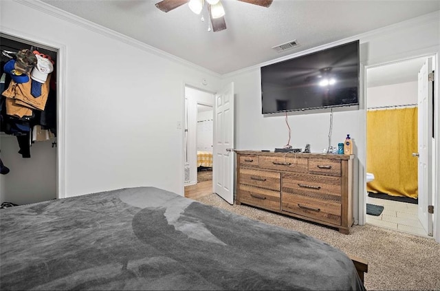 bedroom featuring ceiling fan, light tile patterned flooring, a closet, and ensuite bath