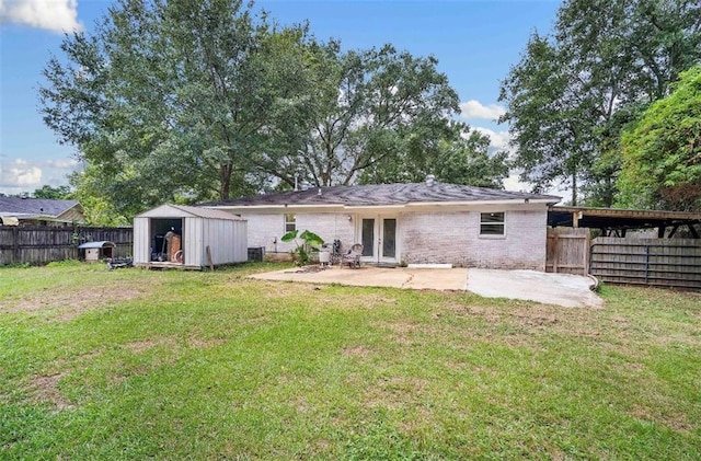 rear view of house featuring a patio, a storage shed, and a lawn