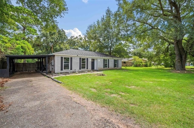 single story home with a carport and a front lawn