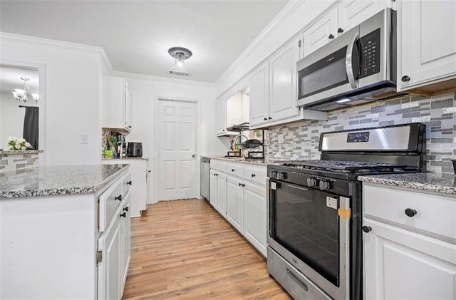 kitchen featuring white cabinetry, appliances with stainless steel finishes, crown molding, and light hardwood / wood-style flooring