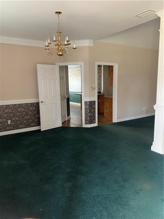 carpeted empty room with an inviting chandelier and ornamental molding