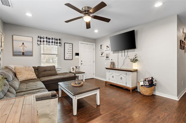 living room with dark wood-type flooring and ceiling fan