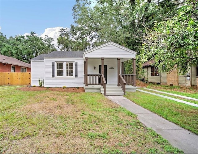 bungalow-style home featuring a porch and a front yard