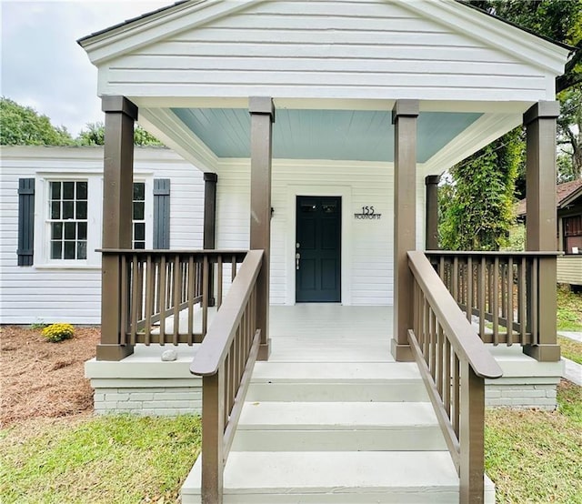 view of exterior entry with covered porch