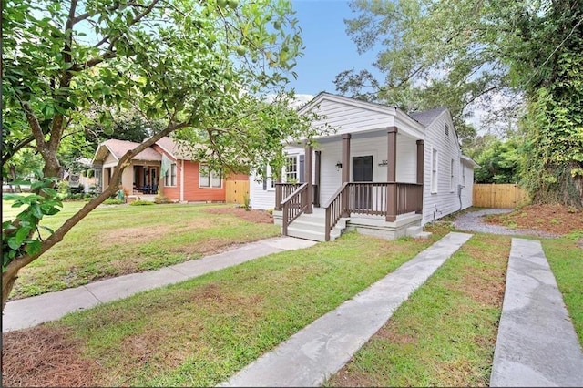 bungalow-style home with a porch and a front lawn