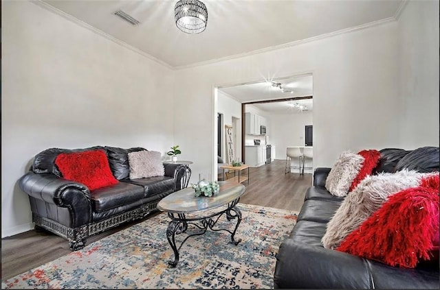 living room featuring hardwood / wood-style flooring and ornamental molding