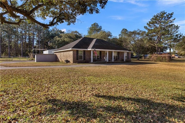 ranch-style house with covered porch and a front yard