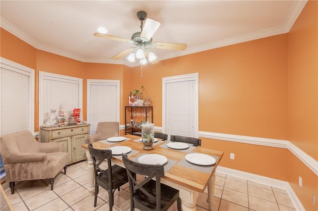 dining space featuring crown molding, ceiling fan, and light tile patterned flooring