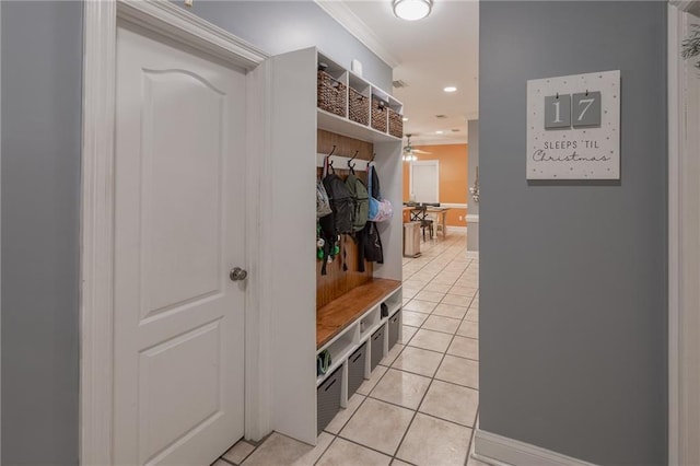 mudroom with light tile patterned floors, ceiling fan, and ornamental molding