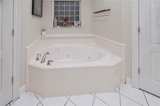 bathroom featuring tile patterned floors and tiled bath